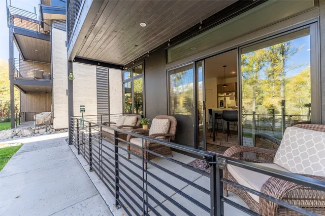 a outdoor space with lots of furniture and glass windows
