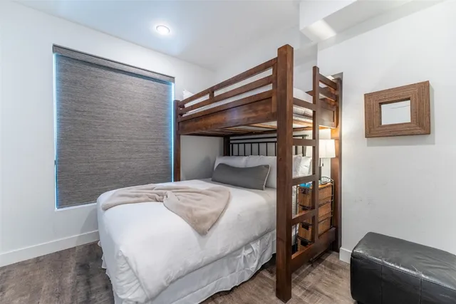 a bedroom with a bed and a chair