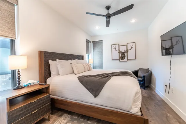 a bedroom with bed and painting on the wall