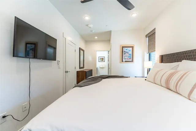 a bedroom with a bed and a flat screen tv