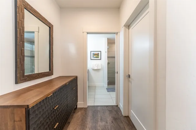 a view of hallway with wooden floor