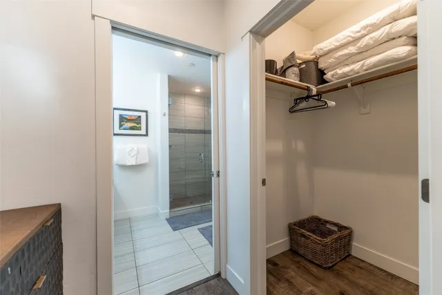 a bathroom with a double vanity sink mirror and shower