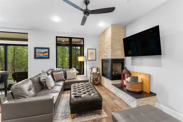 a living room with furniture a flat screen tv and a fireplace