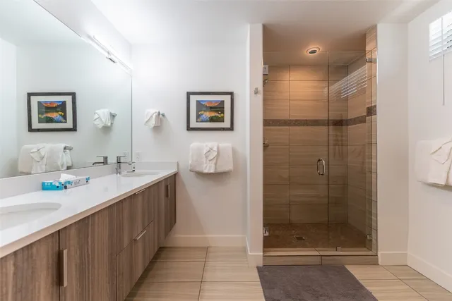 a bathroom with a double vanity sink and a mirror
