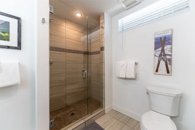 a spacious bathroom with a tub sink and mirror