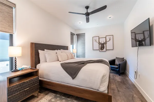 a bedroom with a bed and wooden floor