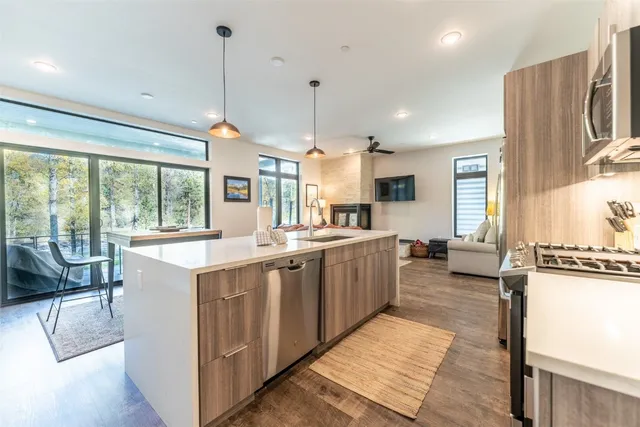 a large white kitchen with a large window