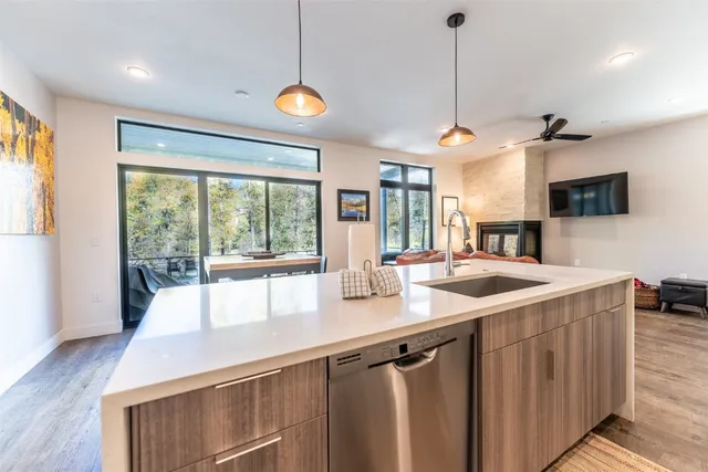 a kitchen with a sink and wooden floor