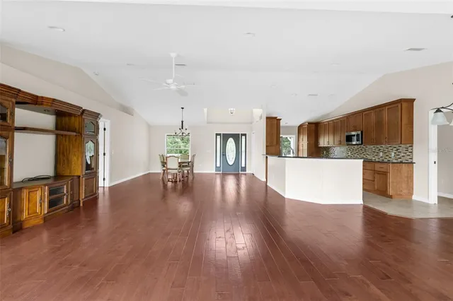 a view of a porch with furniture and a yard
