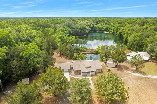 a kitchen with granite countertop a stove a sink and a refrigerator