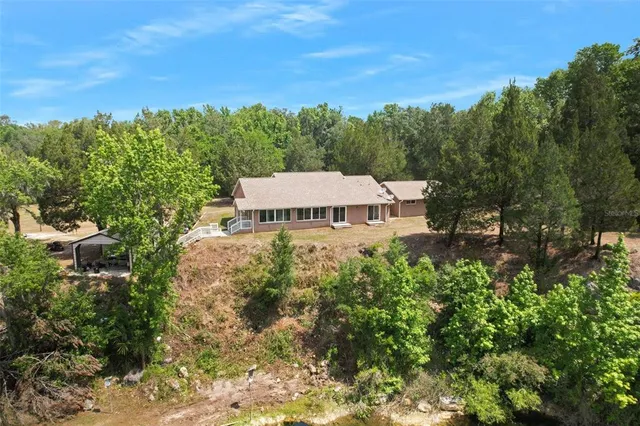 a kitchen with stainless steel appliances kitchen island granite countertop a stove refrigerator and sink