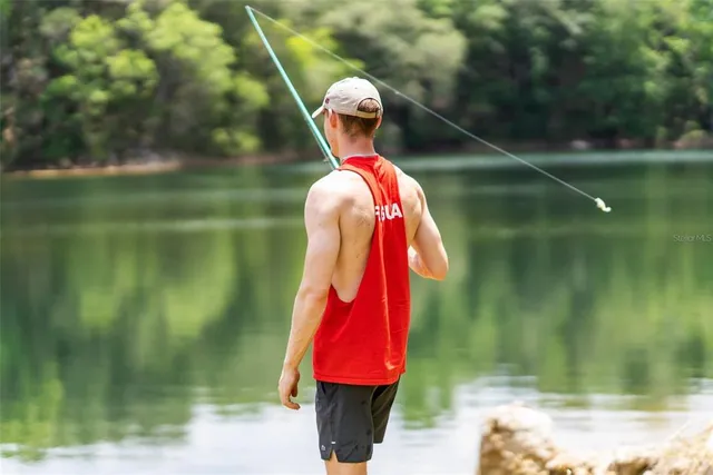 a kitchen with stainless steel appliances granite countertop a refrigerator a stove and a sink