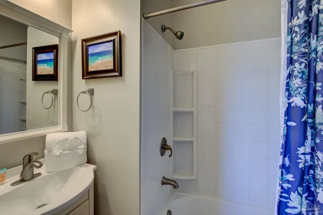a bathroom with a sink a mirror and shower