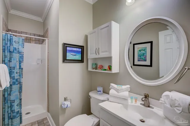 a bathroom with a toilet a sink and a mirror