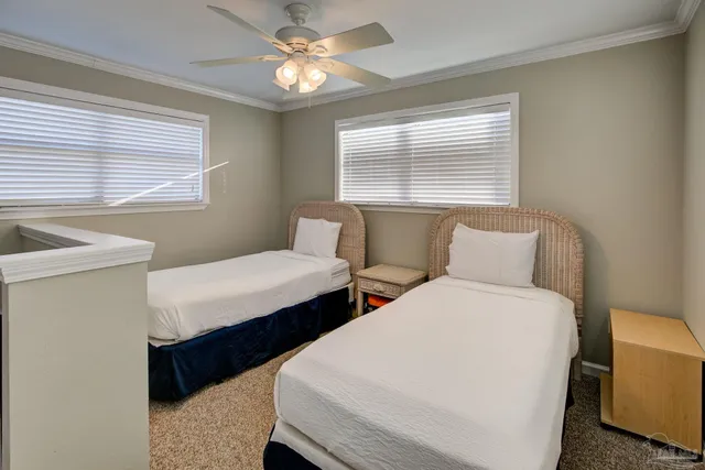 a bedroom with two beds and a window