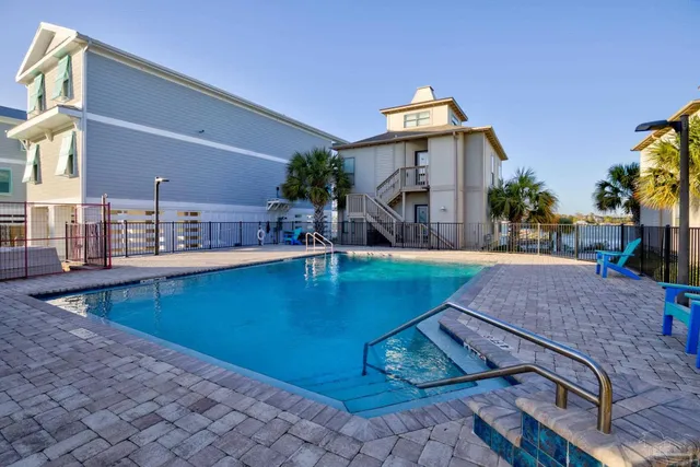 a view of a house with swimming pool and sitting area
