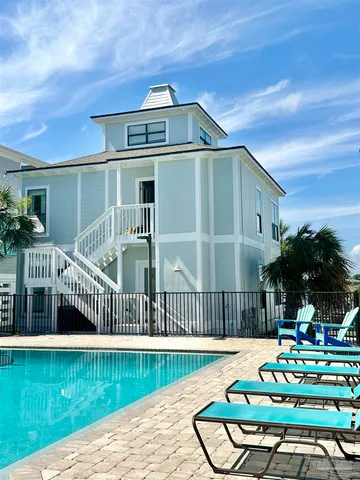 a roof deck with table and chairs potted plants with wooden floor