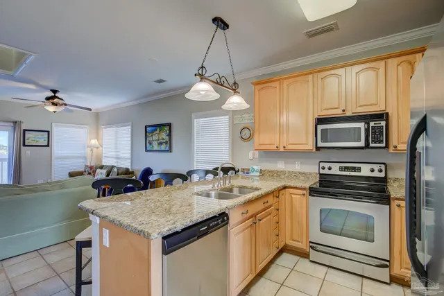 a kitchen with a sink stove and microwave