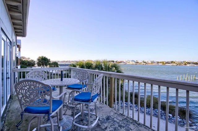 a view of a balcony with chair and wooden floor