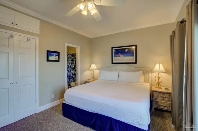 a bedroom with a large bed and a chandelier