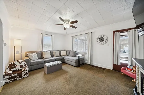 a living room with furniture and a chandelier