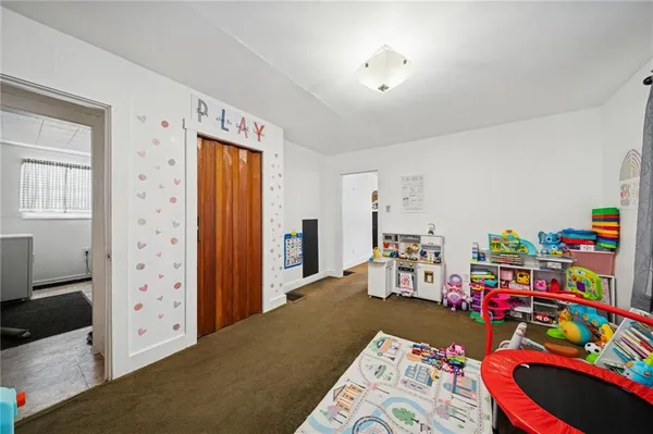 a bed room with furniture and a baby crib