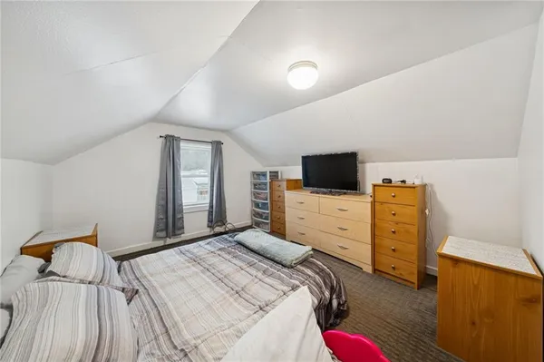 a bedroom with a bed and flat screen tv