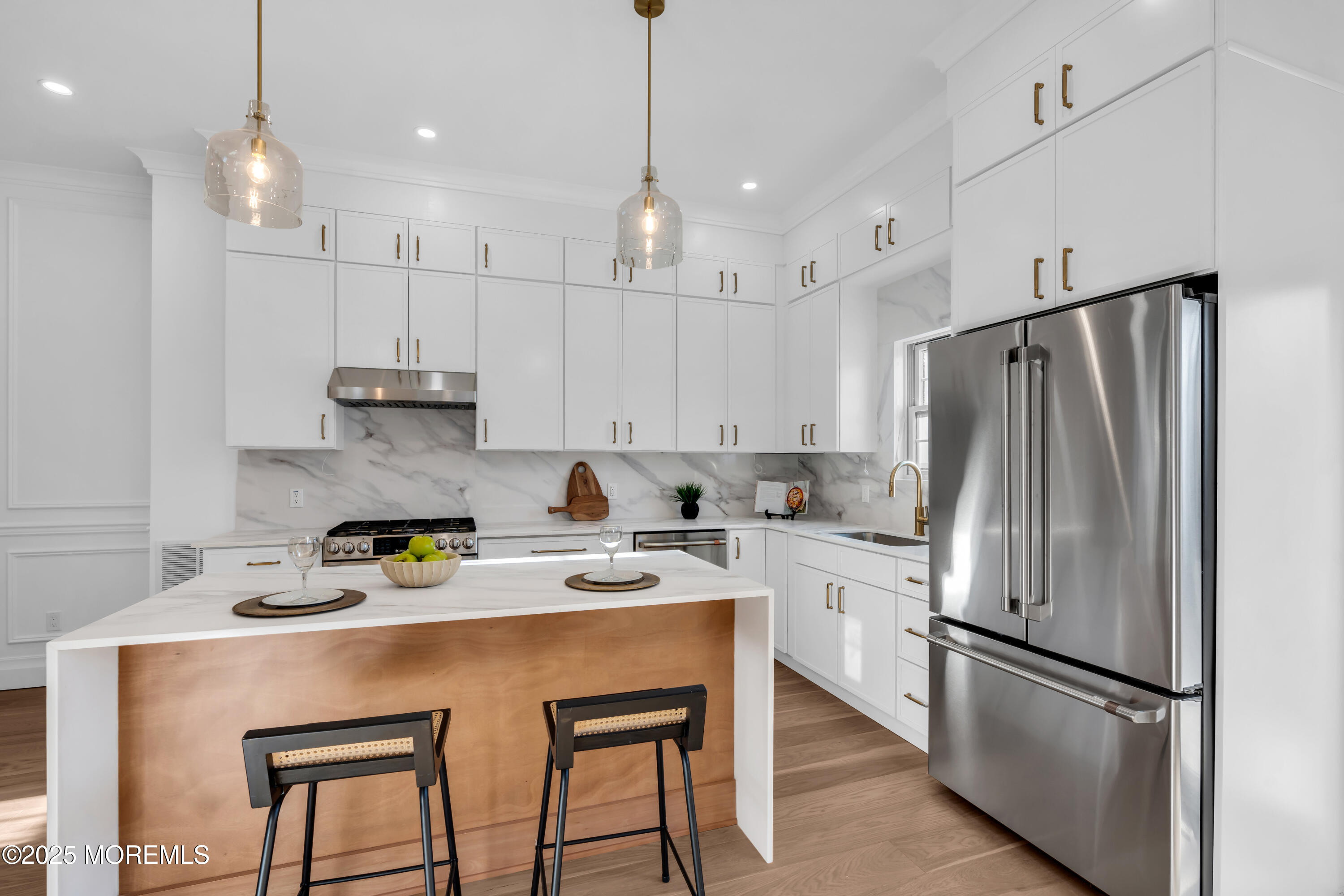 340 River Road Fair Haven, NJ 07704 - Photo 12 of 35 a kitchen with stainless steel appliances granite countertop a refrigerator a sink dishwasher a stove and white cabinets with wooden floor