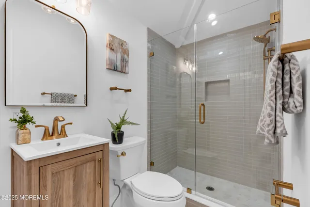 a bathroom with a sink toilet and shower