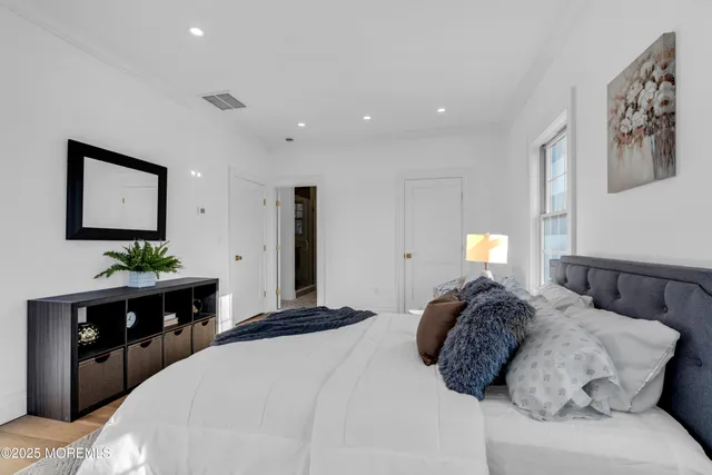 a bed room with a bed and a television