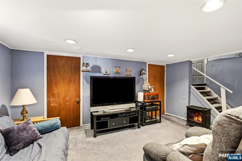 332 Riverside Avenue Lyndhurst, NJ 07071 - Photo 27 of 31 a living room with furniture and a flat screen tv