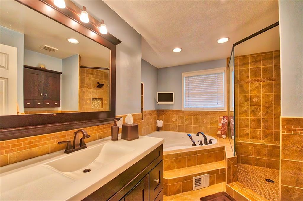 130 Prittstown Road Mount Pleasant, PA 15666 - Photo 7 of 21 Relax in your own personal retreat! This bathroom has great design and functionality. Enjoy the walk-in shower with the bench and high-end shower head. The vanity not only looks pretty, but there is room for all your products when you're getting ready.