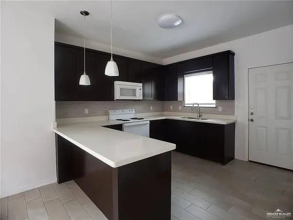 a kitchen with a sink cabinets and window