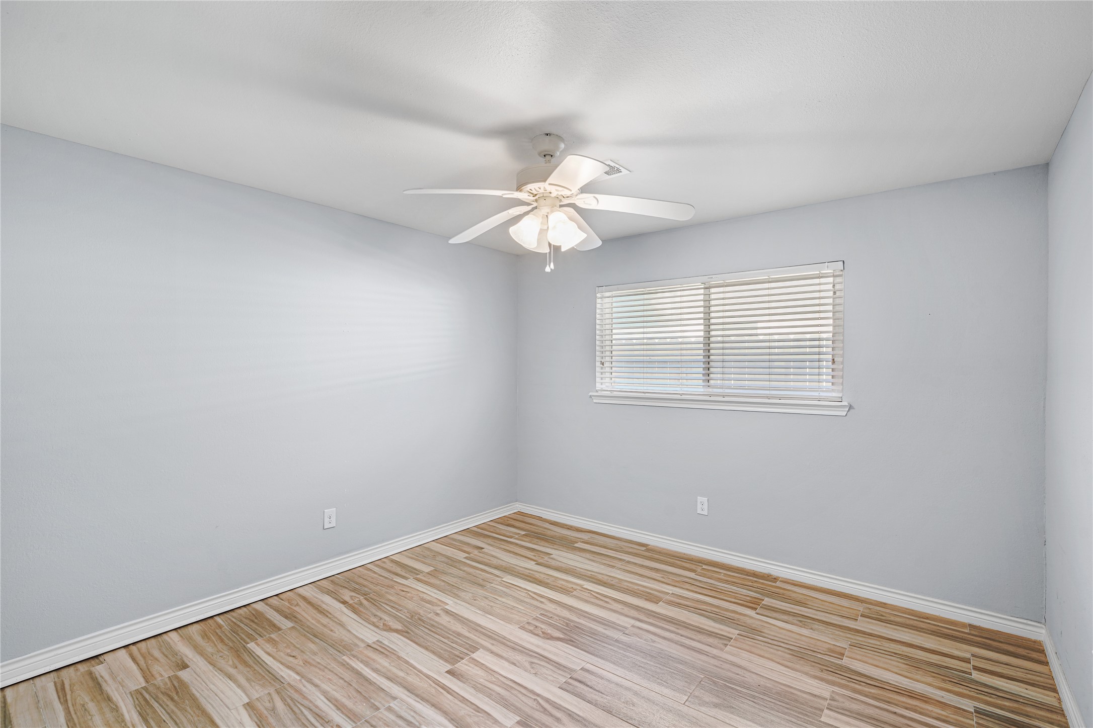 6002 McKnight Street Houston, TX 77035 - Photo 19 of 28 a view of a room with a ceiling fan and wooden floor
