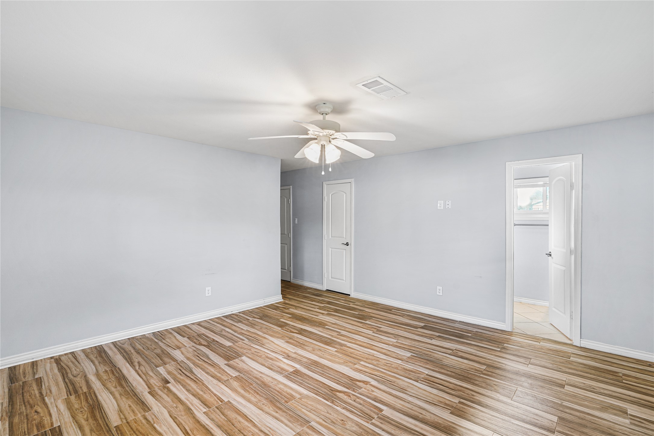 6002 McKnight Street Houston, TX 77035 - Photo 22 of 28 a view of a room with wooden floor and a ceiling fan