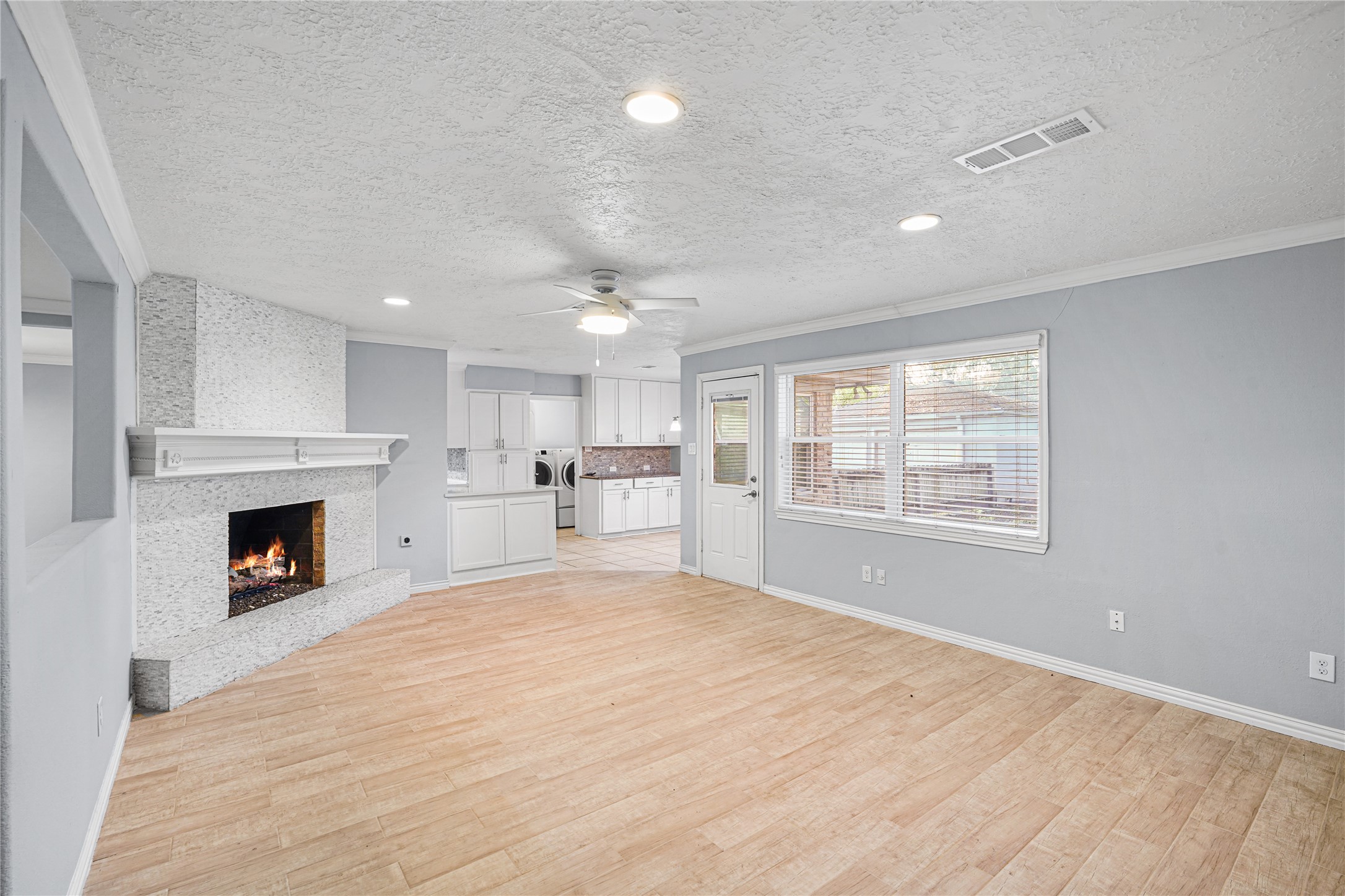 6002 McKnight Street Houston, TX 77035 - Photo 3 of 28 a view of kitchen and empty room with fireplace