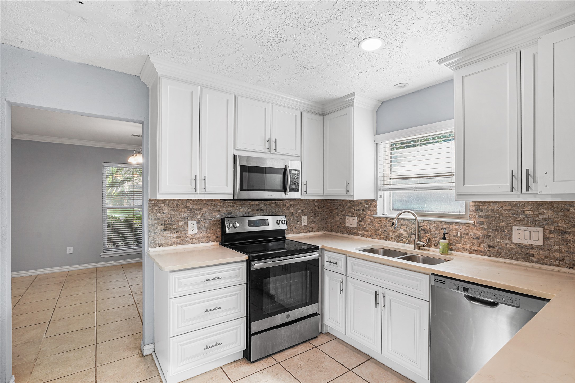 6002 McKnight Street Houston, TX 77035 - Photo 6 of 28 a kitchen with cabinets appliances a sink and a counter top space