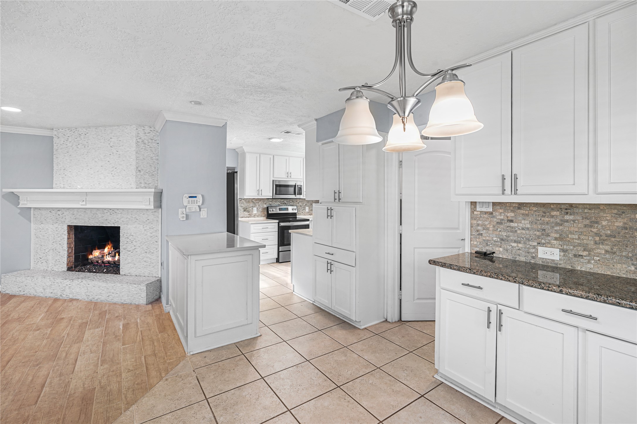 6002 McKnight Street Houston, TX 77035 - Photo 7 of 28 a kitchen with white cabinets and white appliances
