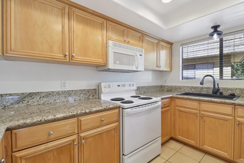 2140 Alpine Glen Place Alpine, CA 91901 - Photo 13 of 34 a kitchen with white cabinets and white appliances