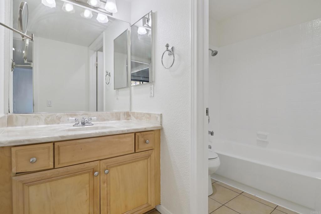 2140 Alpine Glen Place Alpine, CA 91901 - Photo 23 of 34 a bathroom with a granite countertop sink a mirror and a bathtub