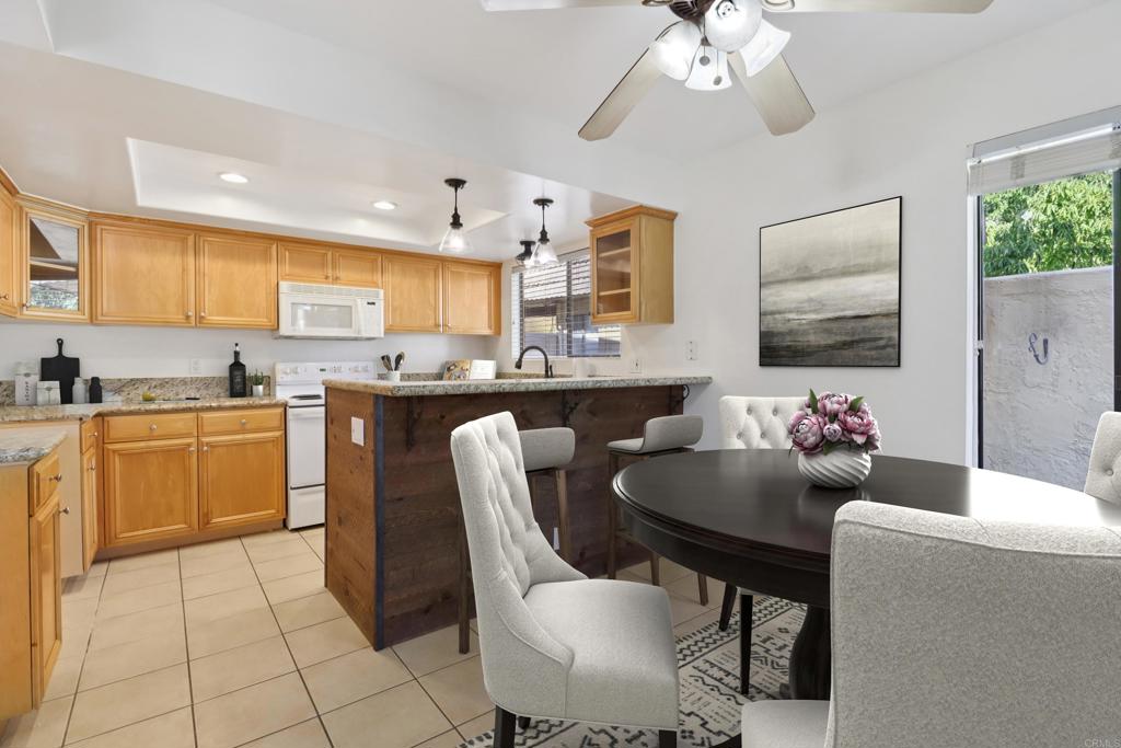 2140 Alpine Glen Place Alpine, CA 91901 - Photo 4 of 34 a kitchen with a dining table chairs cabinets and stainless steel appliances