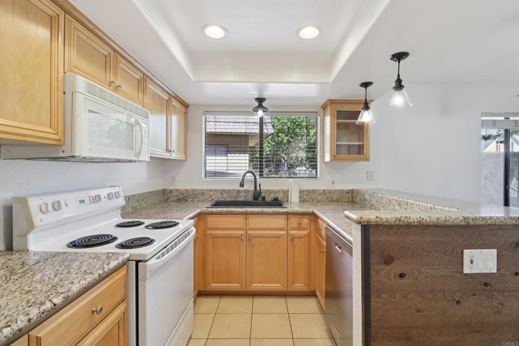 2140 Alpine Glen Place Alpine, CA 91901 - Photo 6 of 34 a kitchen with granite countertop a sink stove and cabinets