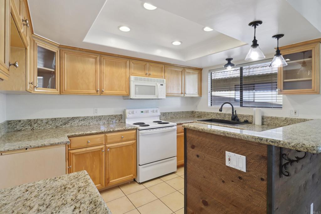 2140 Alpine Glen Place Alpine, CA 91901 - Photo 7 of 34 a kitchen with stainless steel appliances granite countertop a sink stove and cabinets