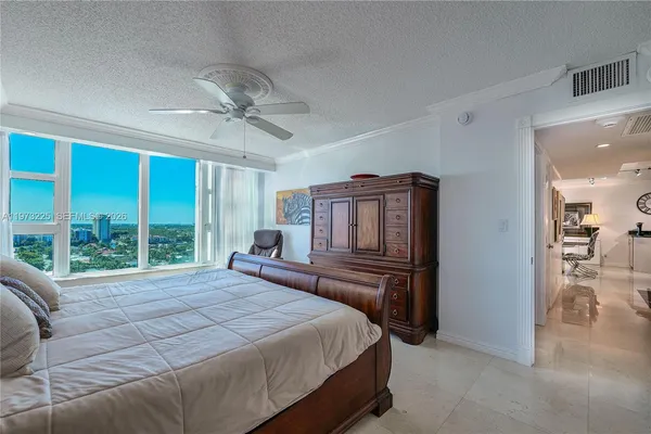 a bedroom with double bed and a chandelier