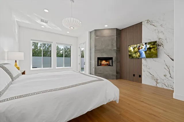 a spacious bedroom with a bed and a fireplace