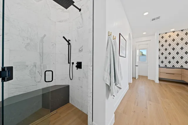 a view of a bathroom with tub shower and windows