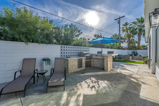 a view of a patio with table and chairs potted plants with wooden floor