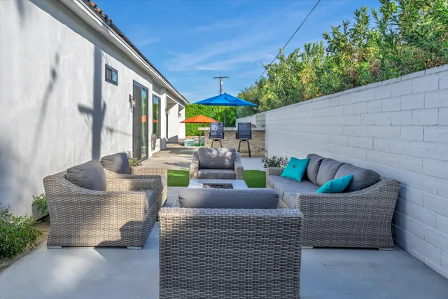 a view of a dining room with furniture large windows and wooden floor