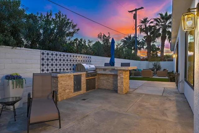 a view of a livingroom with wooden floor and a ceiling fan