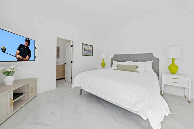 a living room with furniture a window and a flat screen tv